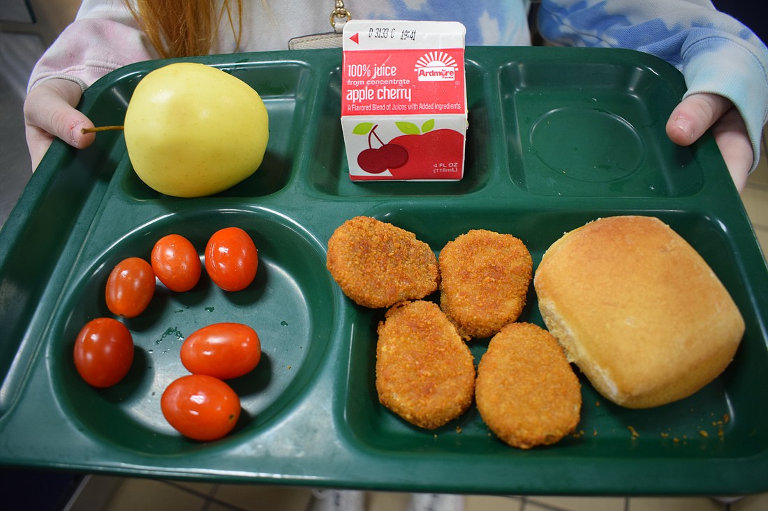 Fruits, veggies, milk, a bread roll and plant-based nuggets make a complete meal.