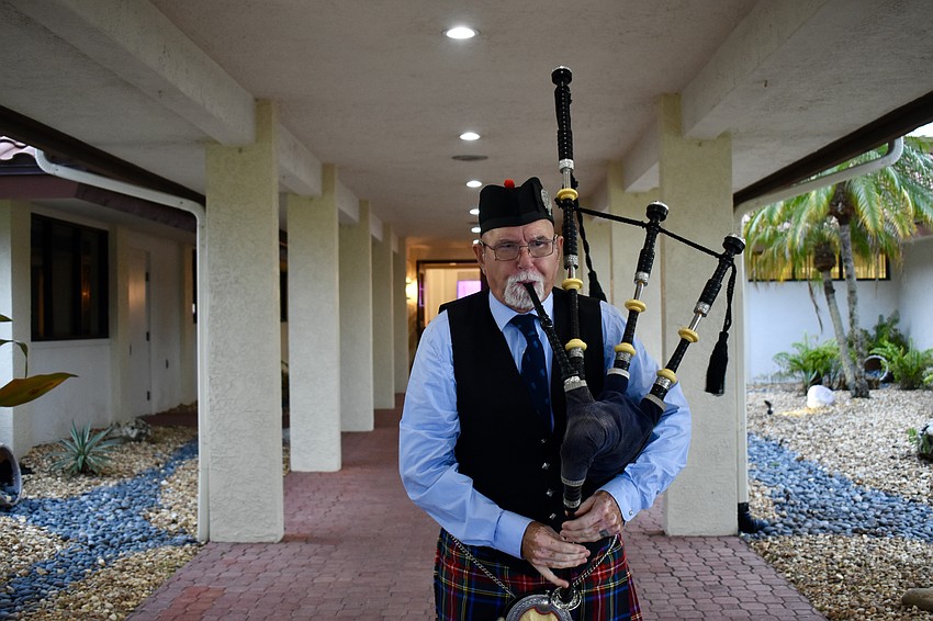 Professional bagpiper William Howard greets guests outiside the Palm Aire Country Club for Burns Night.