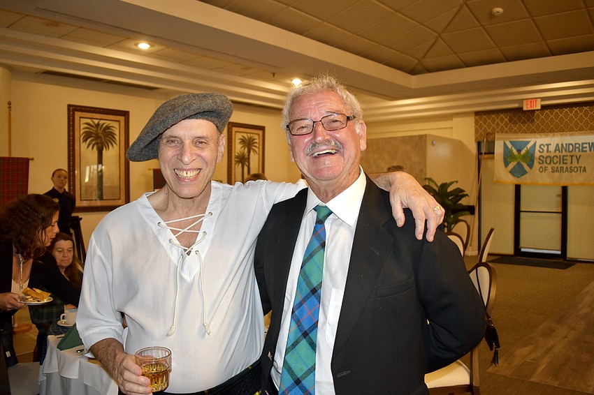 Phil Miner and Ian Young enjoy the scotch before the meal.