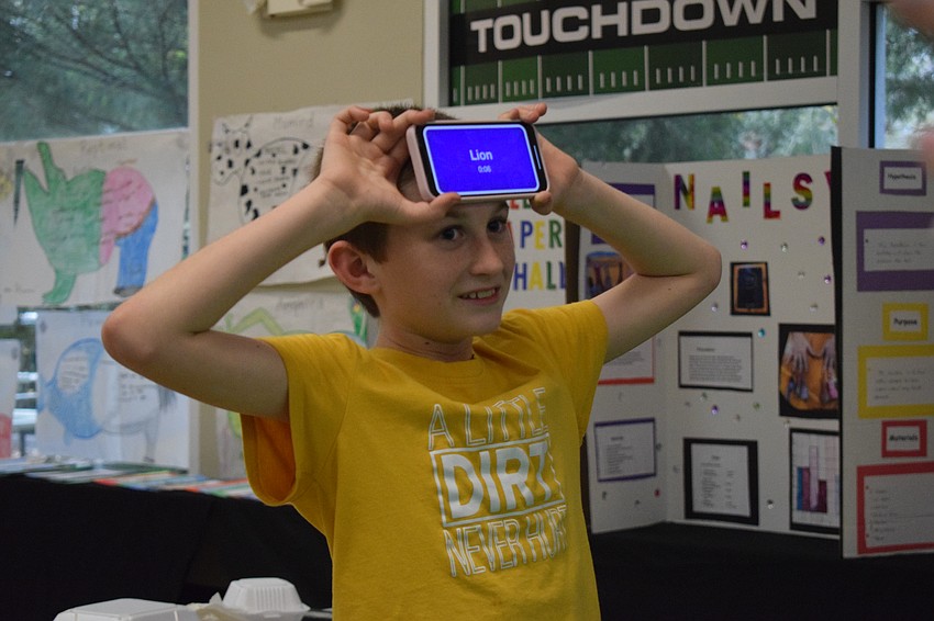 Fourth grader Ryker Anderson tries to guess the correct animals during a game of Headbanz.