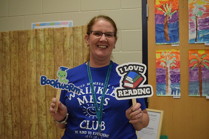Second grade teacher Maureen Geary encourages students to read.