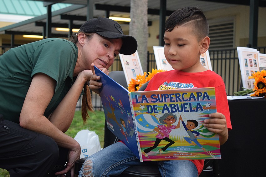 Libby Neily, the director of equine learning for TerraNova, listens to first grader Kaleth Nieto read 