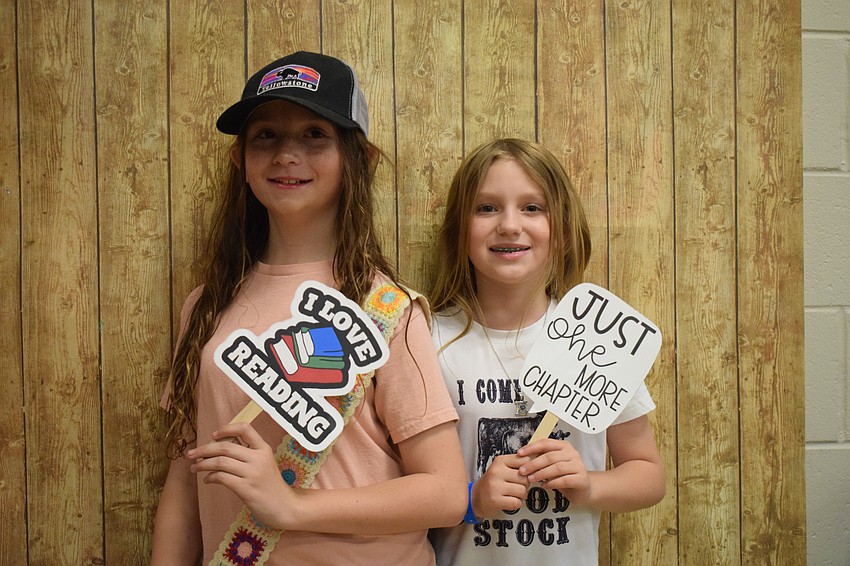 Fourth graders Sareece Cooms and Elle Drake celebrate their love of reading.