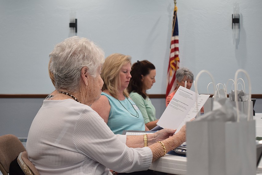 Phyllis Baber reading the St. Mary Star of the Sea Women's Guild guidebook.
