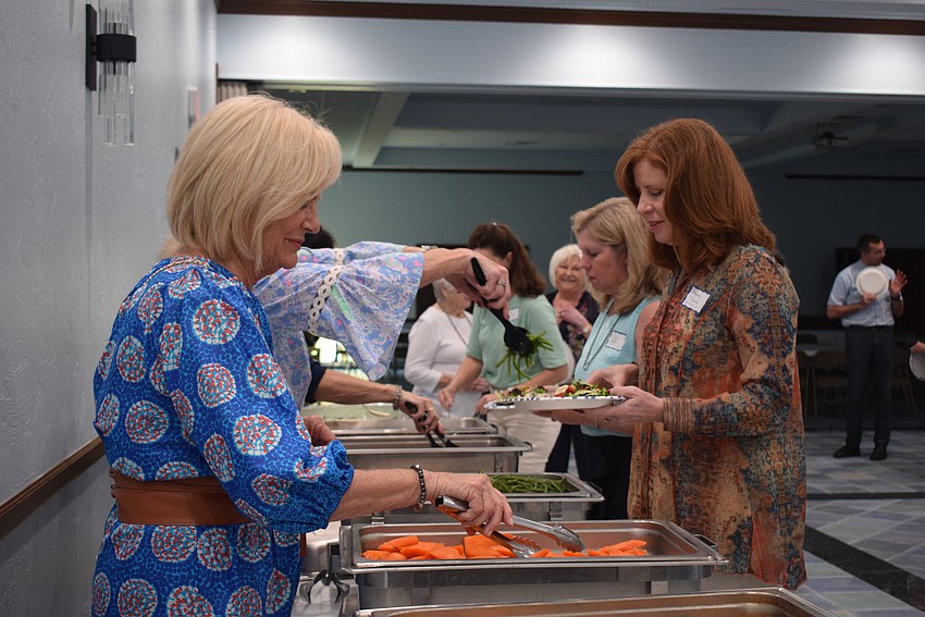 Madeline Reiber serves new members at the St. Mary Star of the Sea new member luncheon.
