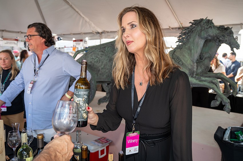 Kristin Hamlin serves up wine for guests.