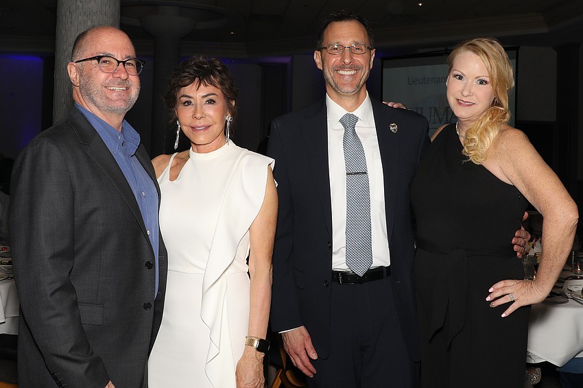 Kirk and Chris Voelker with SPD Deputy Chief Scott Mayforth and wife, Jennifer.