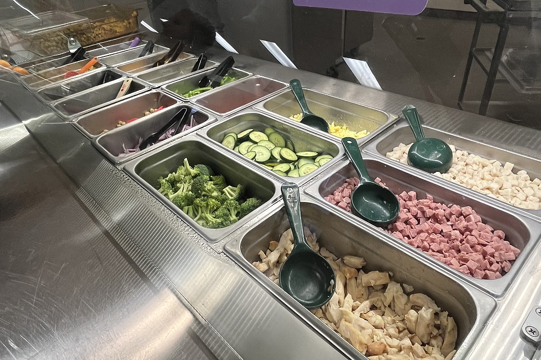 The salad bars in high school cafeterias come with plenty of ingredients for students to choose.