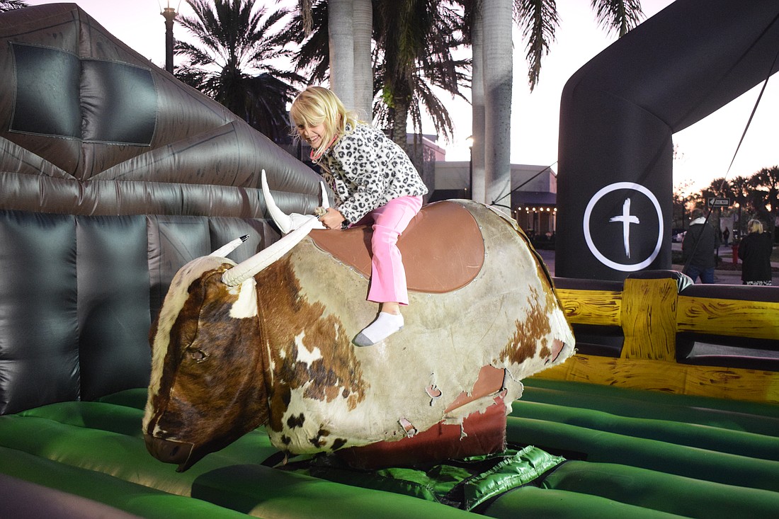 Lakewood Ranch 6-year-old Aurlyn Esler holds on as tight as she can to see how long she can last on the bull.