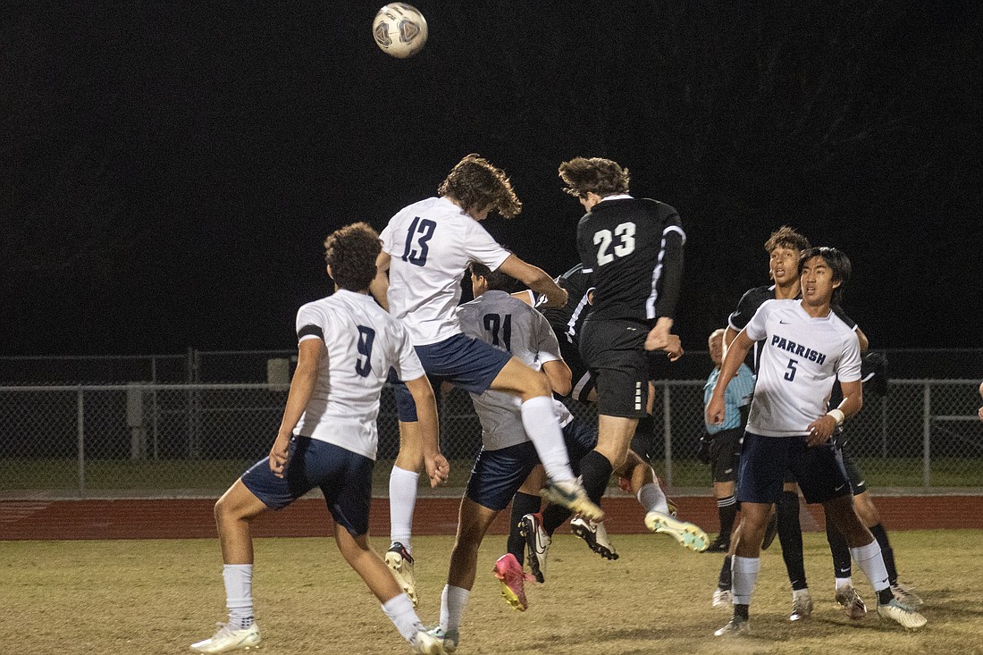 Braden River High senior Zackary Groth (23) leaps for an attempted header against Parrish Community High. The attempt would sail wide of the net and Braden River would lose 1-0.