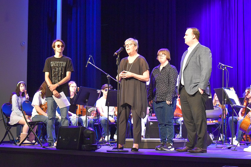 Out-of-door student Kegan Gargano and Manasota BUDS members Patricia Crauwels, Rachel Crauwels and Andrew Riffee introduce the orchestra and tell the audience about Manasota BUDS before the performance.