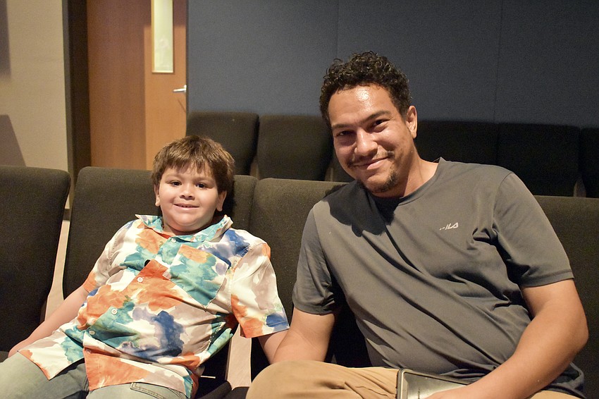 Theo and Chance Bradshaw are waiting to hear Theo's mom, Gabriella Maraia, sing. Maraia is a learning specialist at the Out-of-Door Academy.
