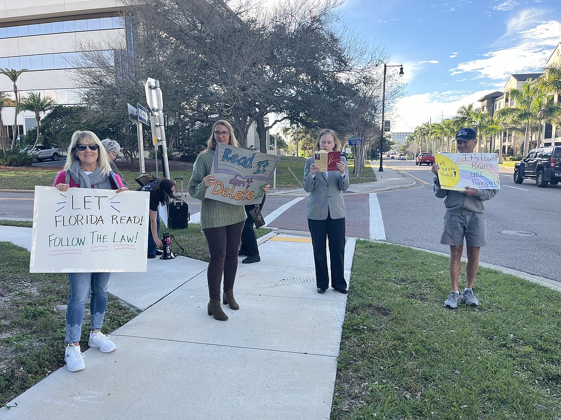 Bradenton's Pam Page, Joanne Telesco, Valerie Lipscomb and David Daniels stand outside the School District of Manatee County's School Support Center to express their disapproval of the district's policy on reviewing books and materials.