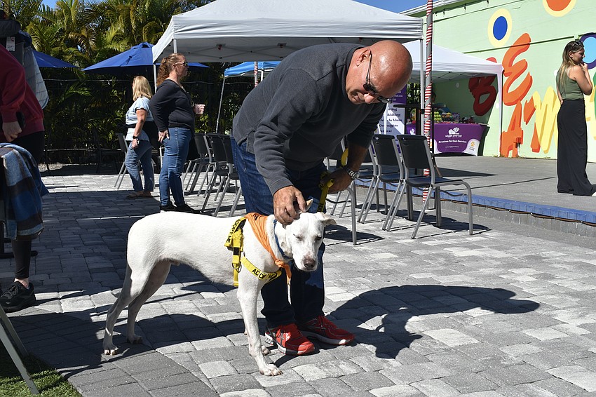Jimmy Walker, a volunteer with Tender Heart Charities, bonds with Tukker.