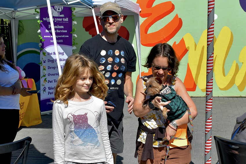 Samaya Laeger, 9, Brian Laeger, Paula Silverman and Ollie walk down from the stage.