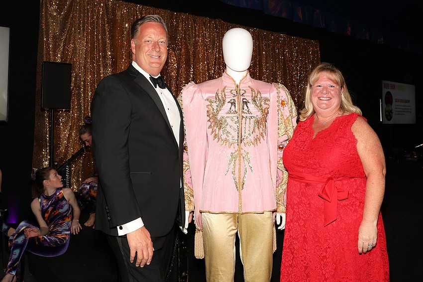Jay Young and his wife, Amy, with an equally well dressed yet unnamed, and unsmiling, mannequin.