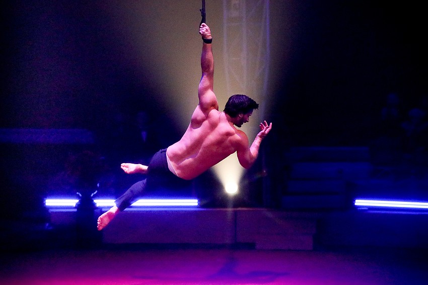 Darren Trull shows his mastery of the aerial straps for the crowd.