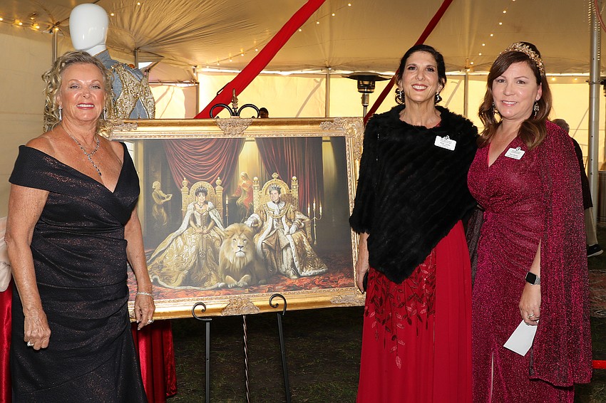 Gala Chair Julie A. Harris, Abby Lasky, and Tonia Bichler admiring a Dolly and Pedro portrait featuring the lion, King.