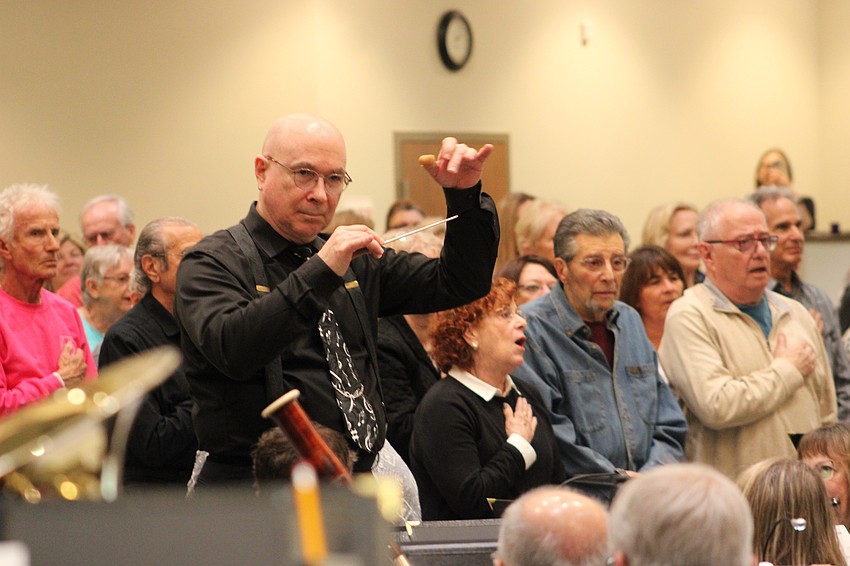Conductor Joe Martinez guides the Lakewood Ranch Wind Ensemble through the National Anthem to begin the 