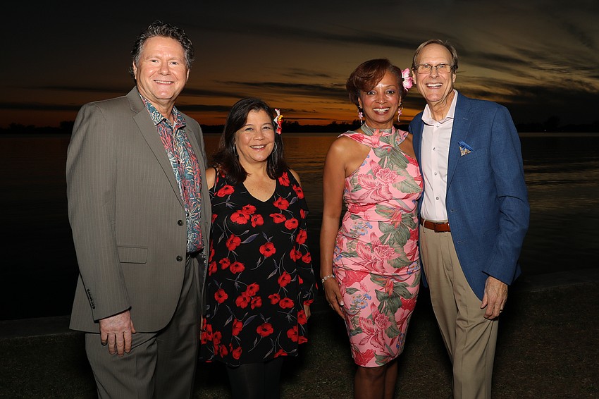 Jake and Angela Hartvigsen are chatting with Alexis and Walter Alm, who flew down from Chicago to support this event.