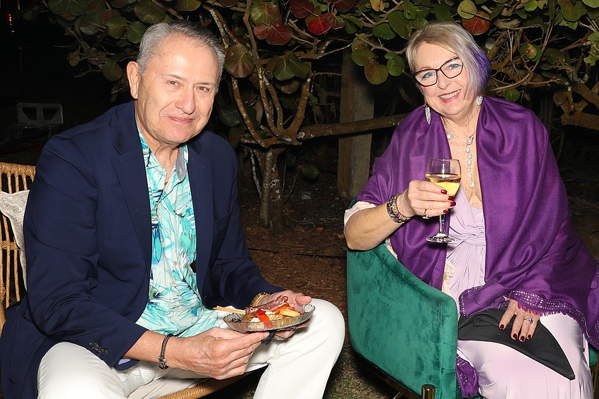 Bob Boston and Pam Revels enjoy appetizers and the orange sunset over Sarasota Bay.