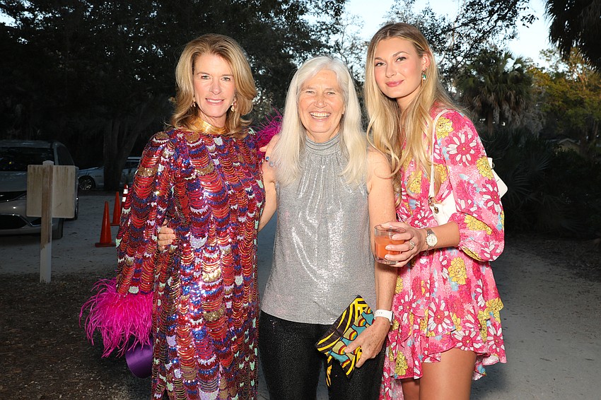 Elizabeth Moore, Hillary Swain, and Marley Hanzel make a colorful entrance at Party in Paradise held at Bay Preserve at Osprey.