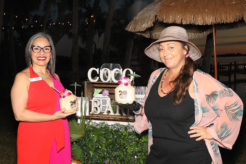 Conservation Foundation's Director of Philanthropy Lee Ann Rodriguez is holding fresh coconut water from Surfing Coconut which is owned by Amanda Chan.