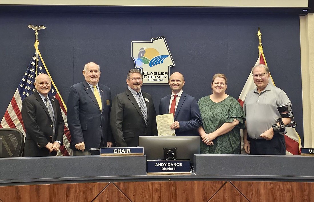 Observer Publisher Brian McMillan, with the Welcome to the Neighborhood Week (Feb. 15-22) proclamation, at the Feb. 5 meeting of the Flagler County Commission. Photo by Sierra Williams
