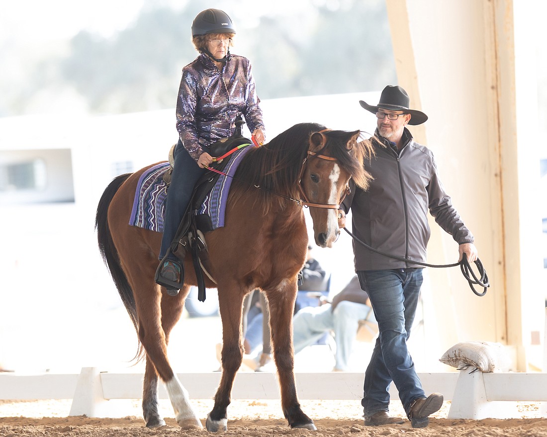 Becky Calevro competes in the Florida State Western Dressage Championships with the help of Mark Hiser, the executive director of Sarasota Manatee Association for Riding Therapy. She is the first exceptional rider to represent SMART in a competition.