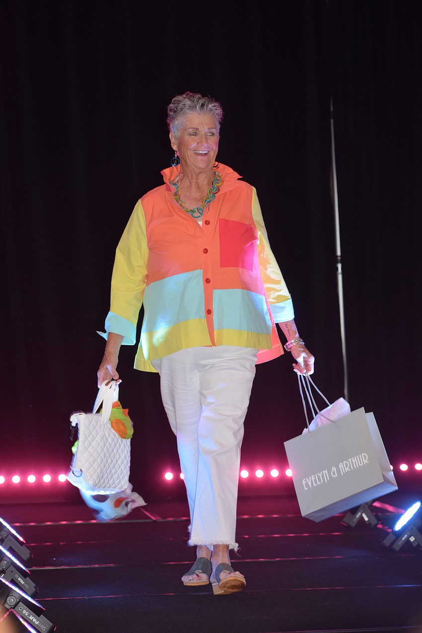University Park's Re Gibson walks the runway to applause from the audience as she brings the colors of summer.