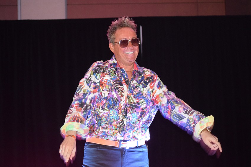 Tyler Butler has fun waving to the audience and dancing down the runway.