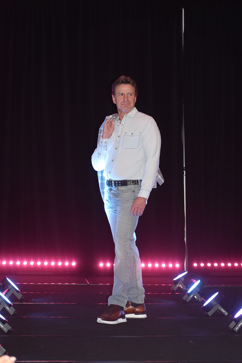 University Park's Bart Schubert takes his jacket off before stopping to pose halfway down the runway.