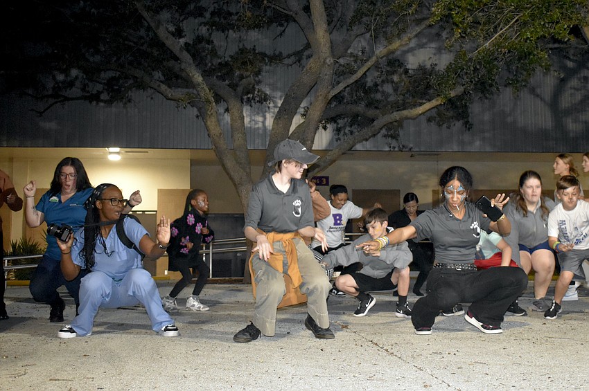 Attendees dance together, with Talia Von Bender, Jamie Taylor and Marisa Von Bender in front.