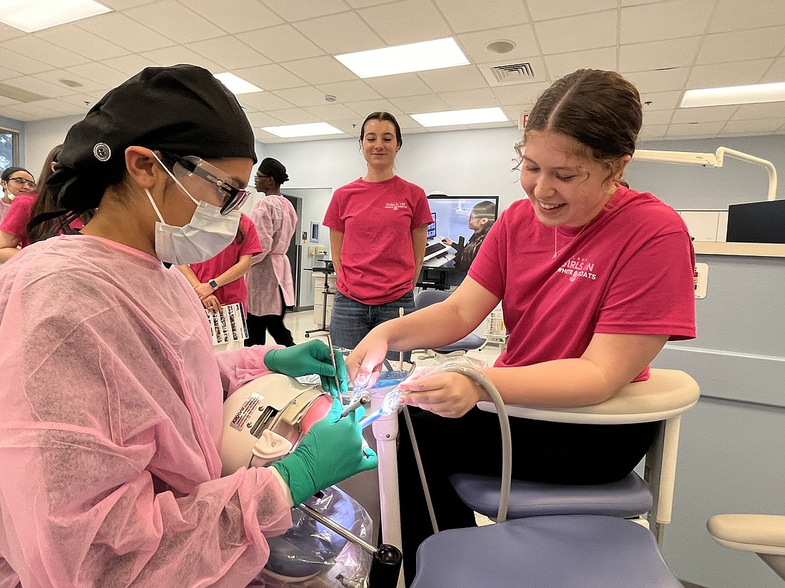 Nayeli Centeno, a Manatee Technical College Dental Assisting student, teaches Vaylin Jensen, a Lakewood Ranch High School junior, how to suction a mouth.