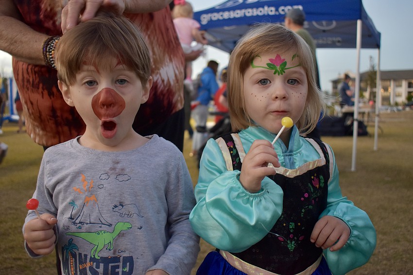 Twins Olin and Arleana Croce, 2, are painted to look like Sven and Anna from 