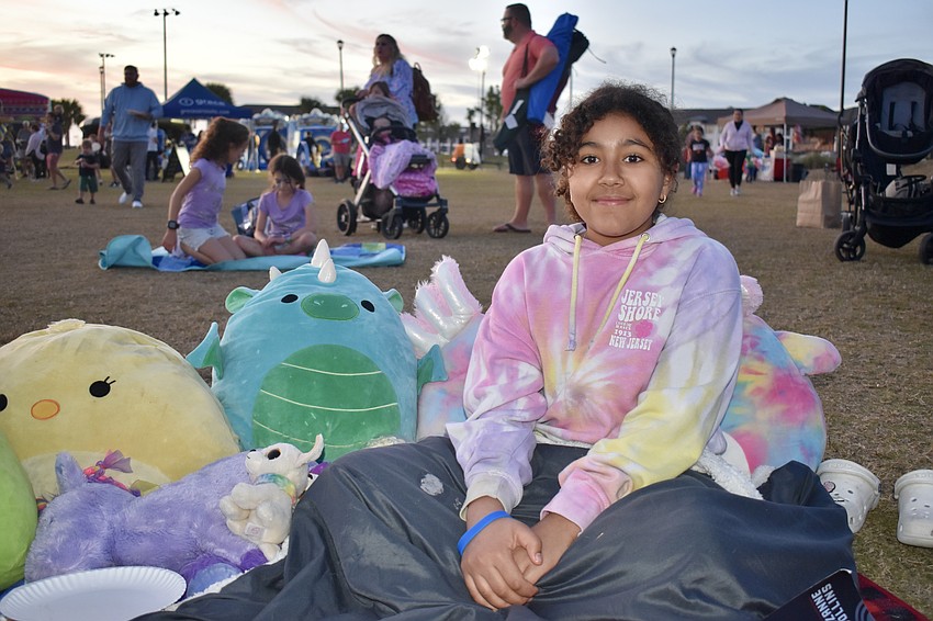 Brianna Hilliard, 11, brings blankets and Squishmallows to stay warm and cozy through the movie.