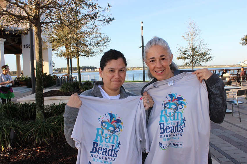 Bradenton's Melissa Ruiz and University Park's Denise Trothe check out their race t-shirts.