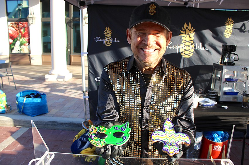 Mike Schenk of Pineapple Kitchen shows off the pastries specially made for the Run for the Beads race at Waterside Place.
