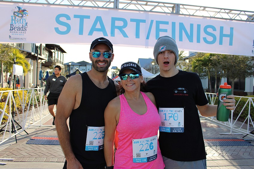 LakeHouse Cove's Josh Potts, Karen DiPietro and Keagan DiPietro show off their energy before the start of the race at Waterside Place.