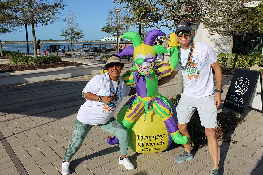 Race volunteer Bee Storm gets together with Run for the Beads Co-Chair David Ahrens before they hand out medals to the runners.