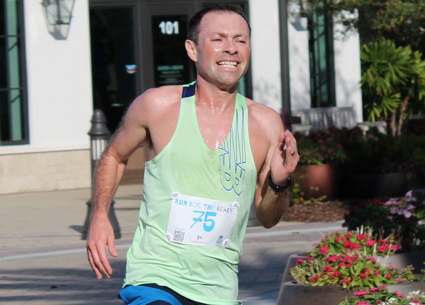 Lakewood Ranch's David Proudfoot crosses the finish line in 16:40 to win the Run for the Beads for the second consecutive year.