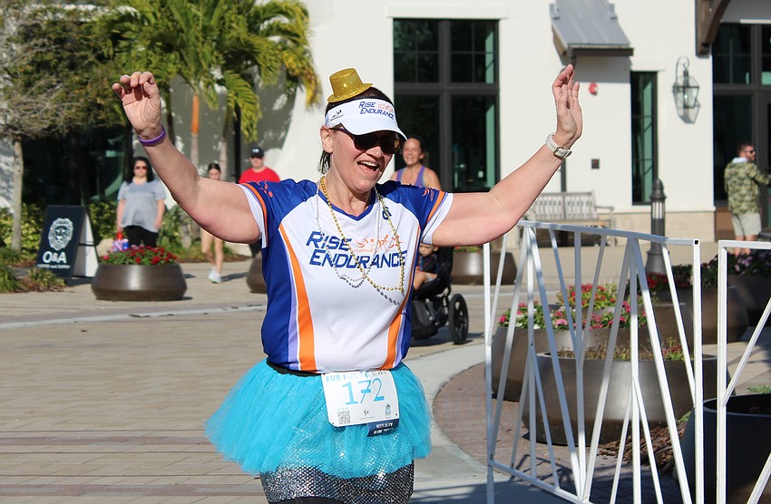 Sarasota's Sabrina Scrivanich celebrates at the end of the Run for the Beads.