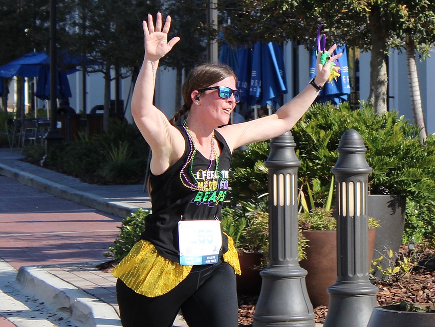 Bradenton's Stephanie Cooley crosses the finish line of Run for the Beads. She said every race medal represents an accomplishment to her since she has lost 140 pounds.