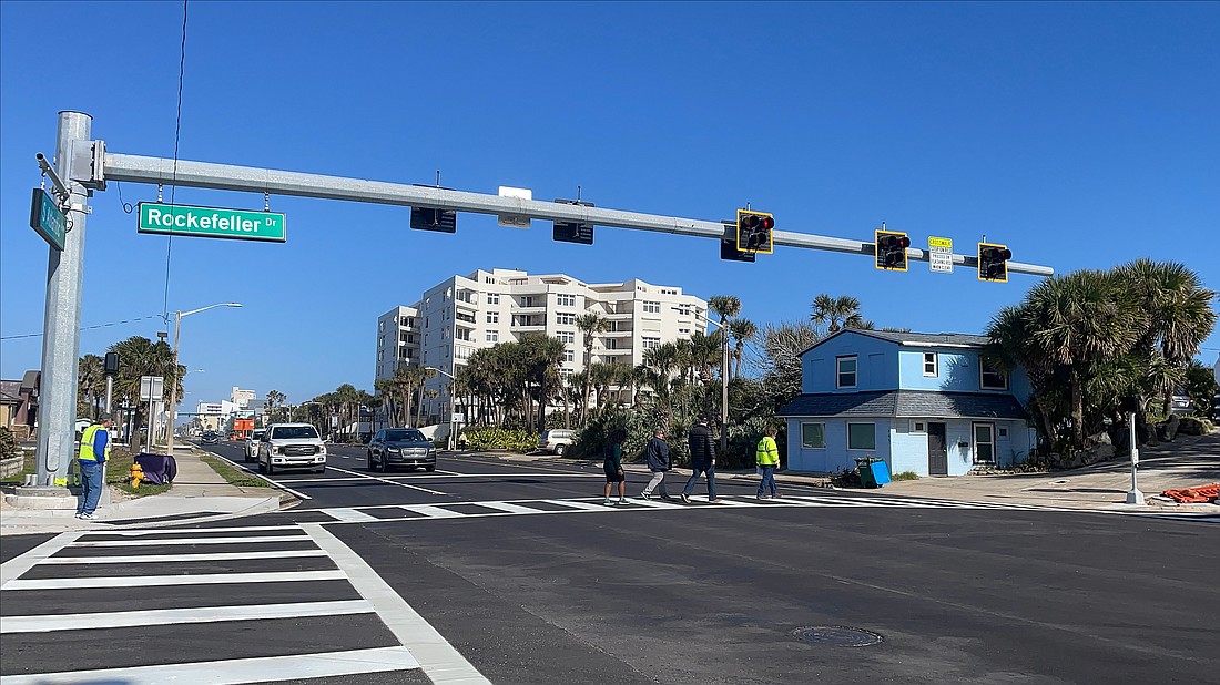 People cross A1A using the new pedestrian hybrid beacon at Rockefeller Drive and A1A. Photo courtesy of FDOT