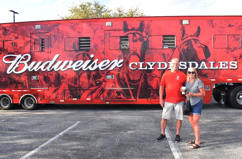 Sarasota's Marty and Karen Van Praet stand in front of the 50-foot tractor trailer that transports the huge animals.