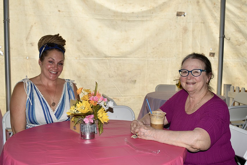 Bradenton residents Jamie Davison and Salli McNeel are taking a break from shopping. The only thing they don't plan on buying is a golf cart because it won't fit in the car.