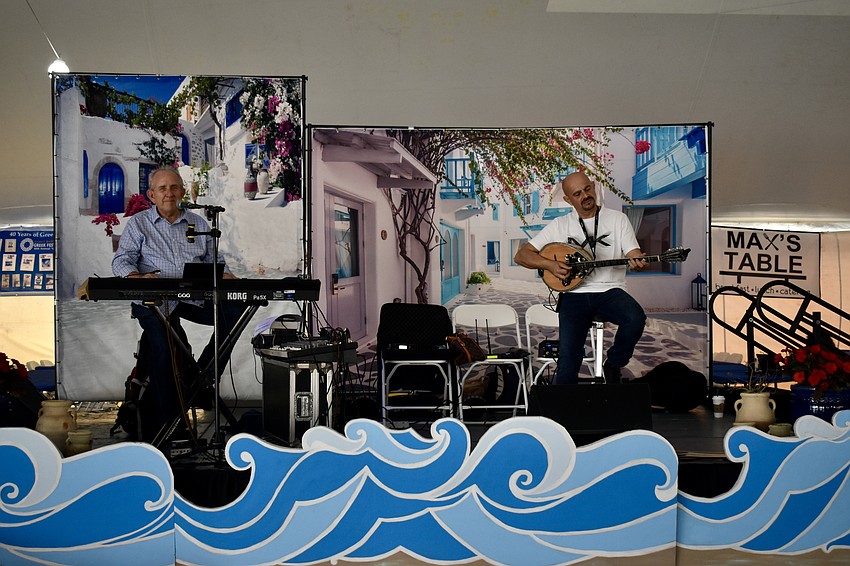 Dino Gheofilos and Simos Nikolopoulos play Greek music for the crowd.