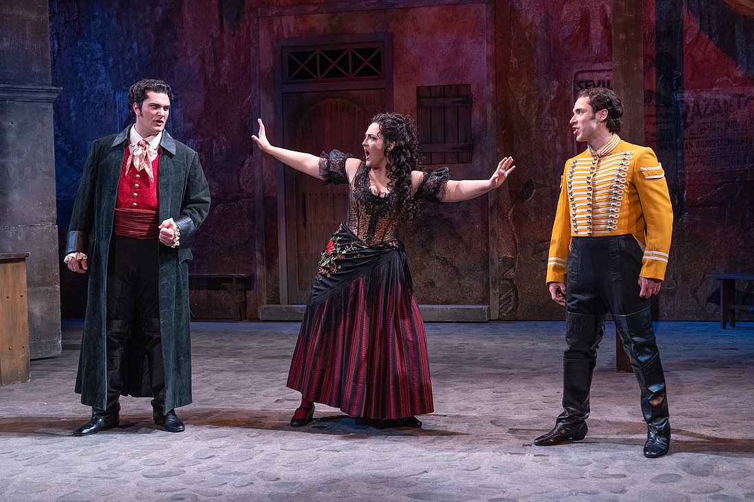 Chelsea Laggan (center) stars as a carefree gypsy caught in a tragic love triangle between a bullfighter (Andrew Manea, left) and a guard (Victor Starsky) in Sarasota Opera's production of "Carmen."