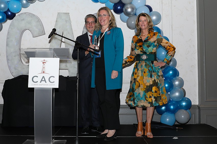 Jennifer Rominiecki receives the Beacon Award from CAC's Bob Bunting and Elizabeth Moore for her part in climate adaptation at Marie Selby Botanical Gardens.