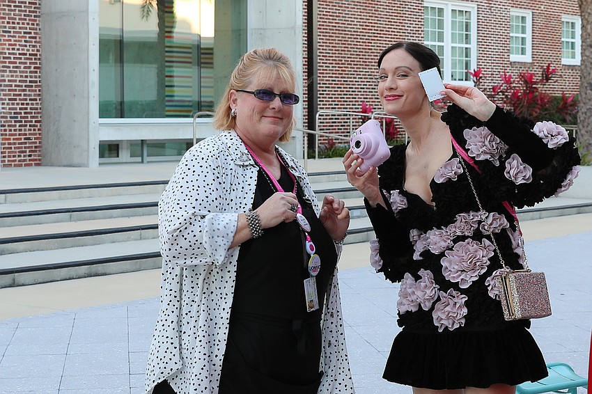Margo Tibbe receives Instax camera instructions from SAM's director of special events, Laura Stewart Wood